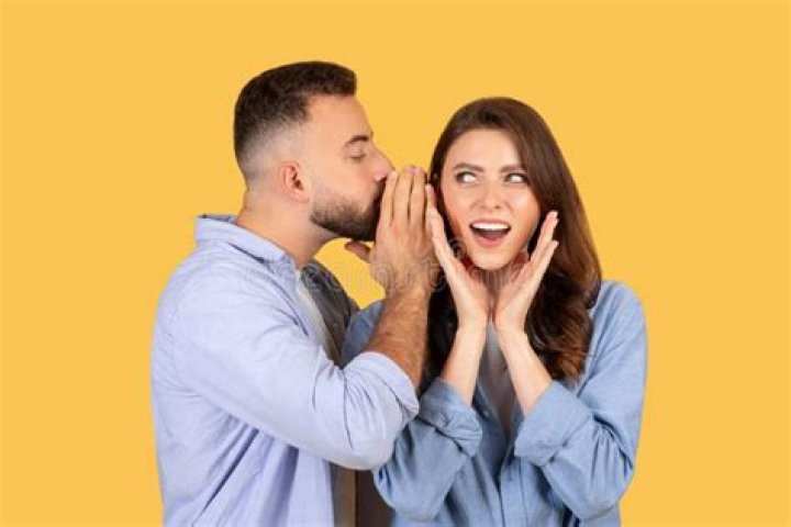 a man whispers into a woman's ear in Dangerous Liasons, the woman wears a bonnet and the man wears a white shirt with a tie