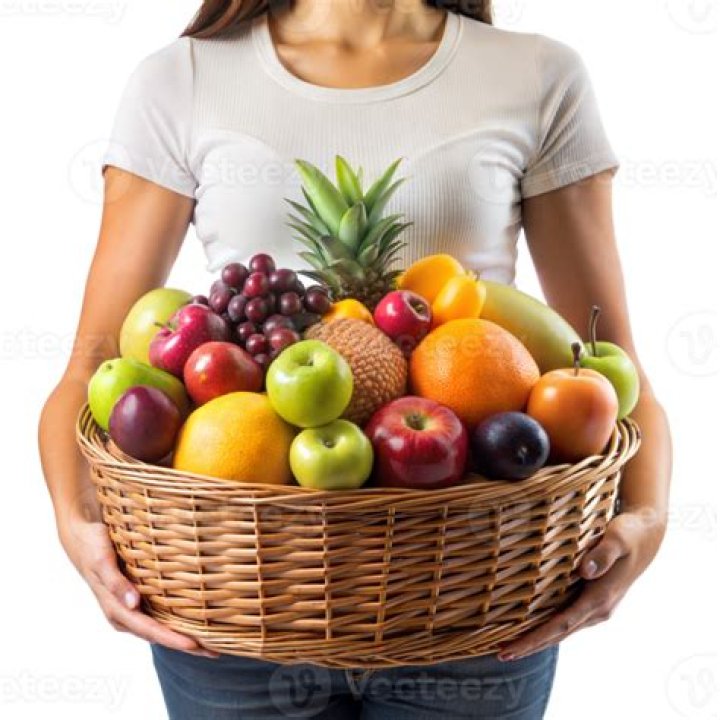a woman is holding a shopping cart and smiling