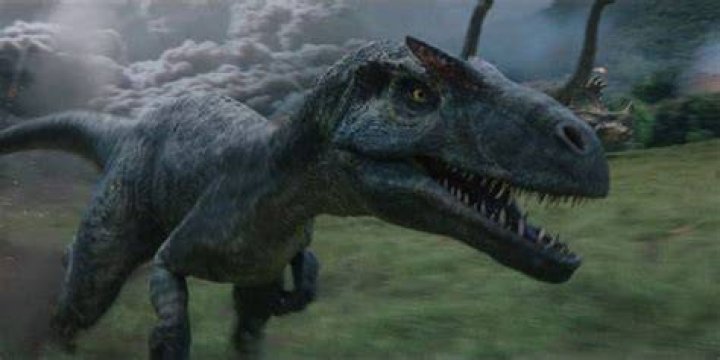 An Allosaurus runs away from the exploding volcano ash cloud on Isla Nublar in Jurassic World Fallen Kingdom