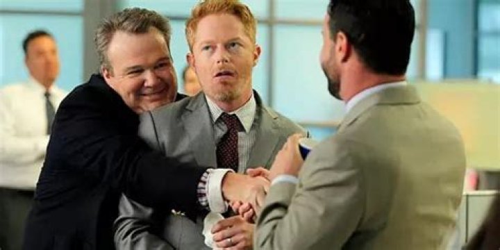 Cam hugging Mitch at work on Modern Family