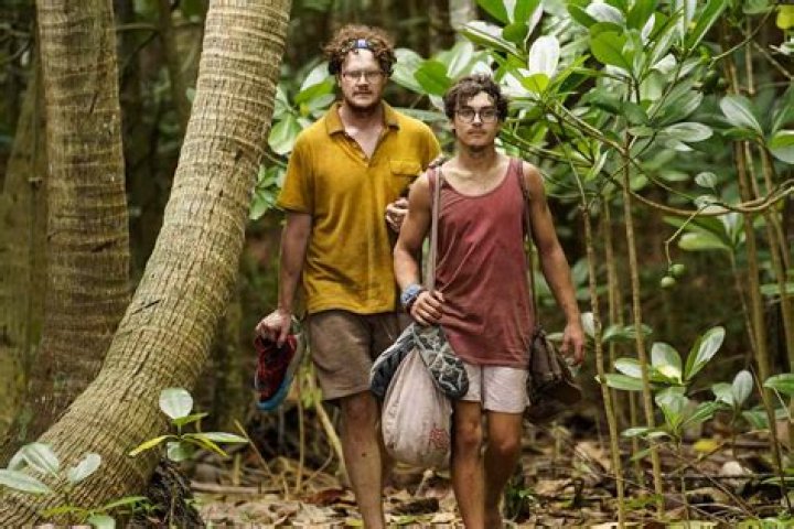 Carson Garrett on Survivor 44 smiling in red top