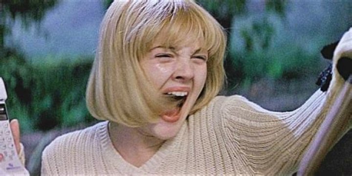 Casey screams as she is grabbed by Ghostface in Scream.