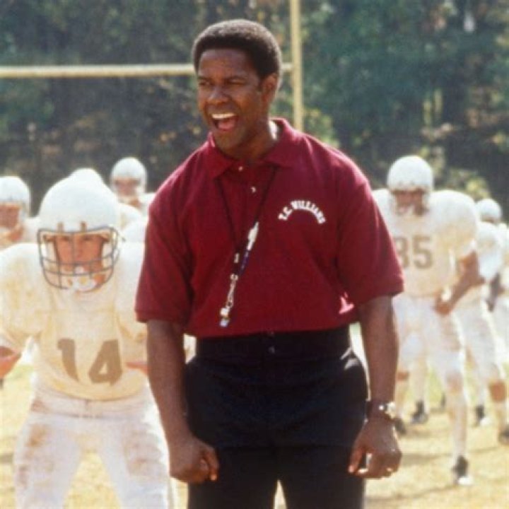 Denzel Washington holding a basketball under his arm on a court in He Got Game