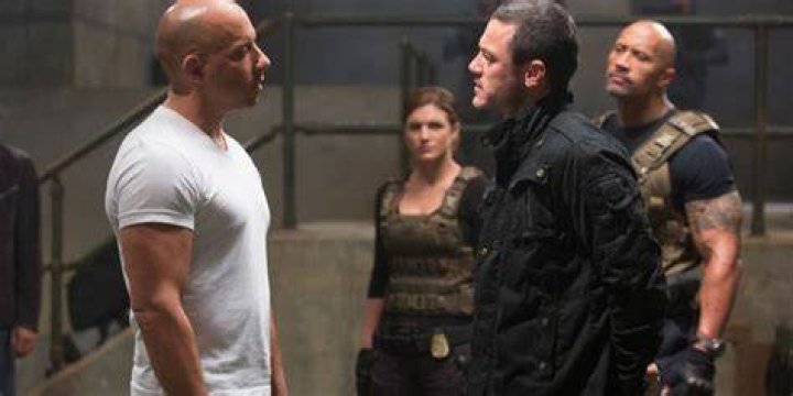 Dom and Deckard confronting each other while others look on in Fast and Furious 6