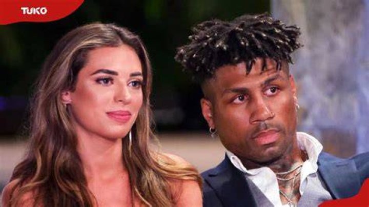 Dom and Georgia on Perfect Match laying back on sofa