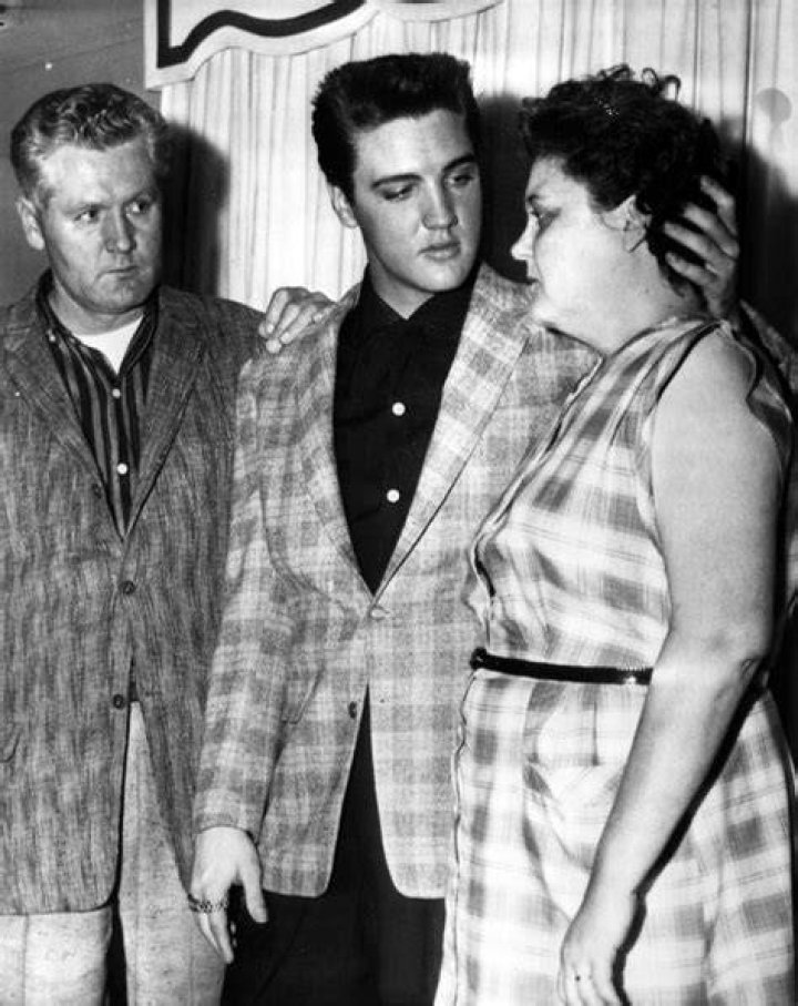 Elvis comforts his mother Gladys and his father Vernon on the eve of his induction into the US Army. Photo / AP