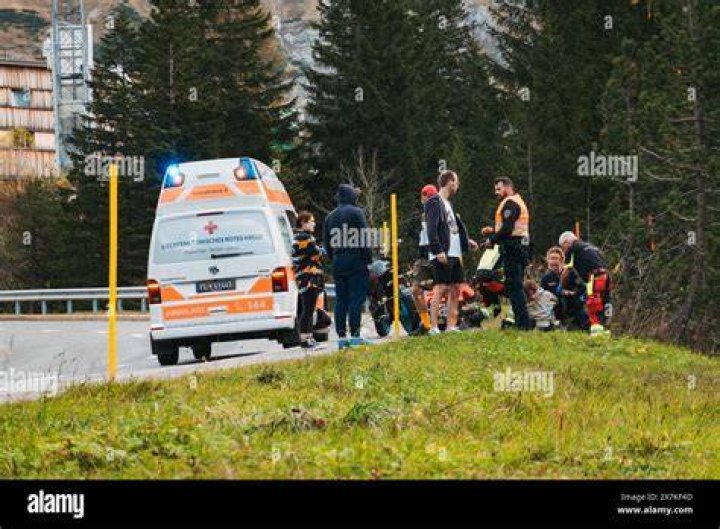 Emergency personnel tend to a woman pulled from the submerged vehicle stuck in rushing rapids. Photo / AP 