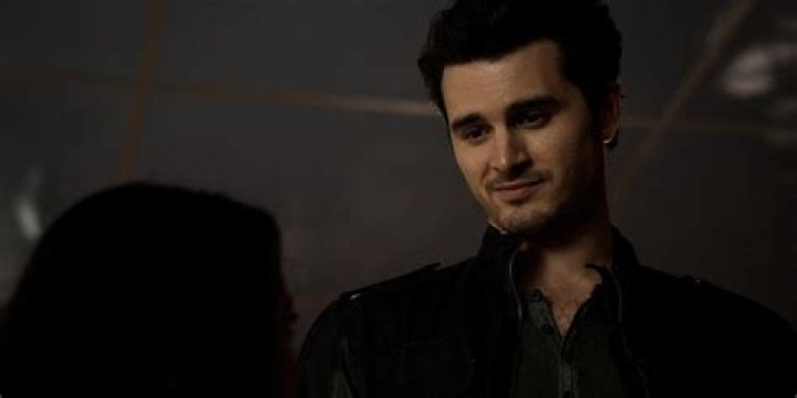 Enzo smiling down at someone.