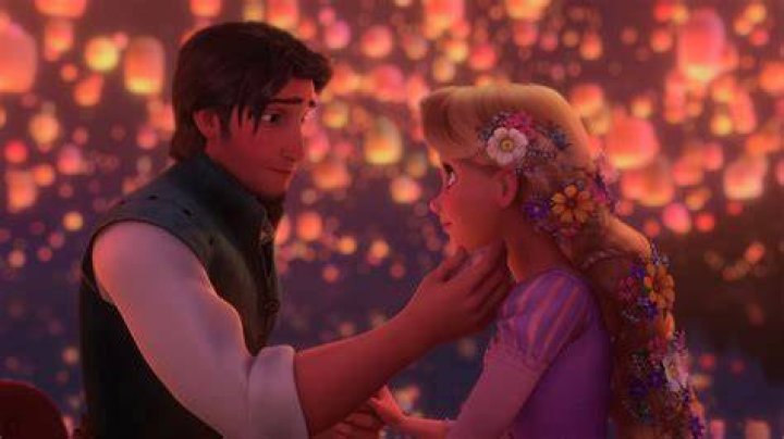 Flynn watching Rapunzel as she sits on a pond stone in Tangled
