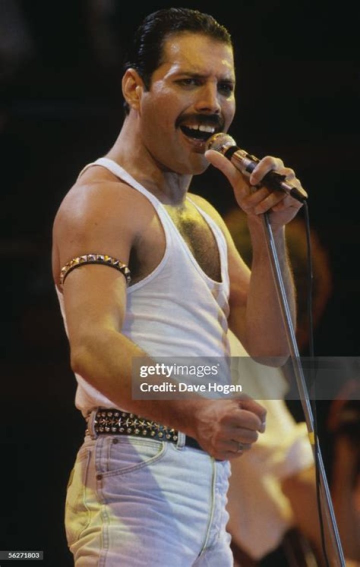 Freddie Mercury during Live Aid at Wembley Stadium (L). The singer as a young boy (R) Freddie Mercury during Live Aid at Wembley Stadium (L). The singer as a young boy (R)