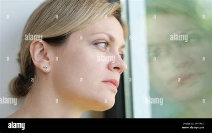 Guzman looks out the window of an airplane. Photo / AP