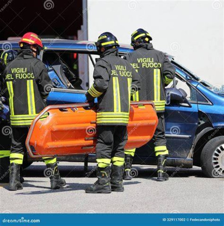 Italian firefighters escort a cruise passenger rescued from the Costa Concordia. Photo / Gregorio Borgia