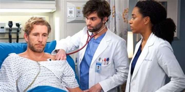 Jake Borelli as Schmitt Checking a Patient's Heart in Grey's Anatomy