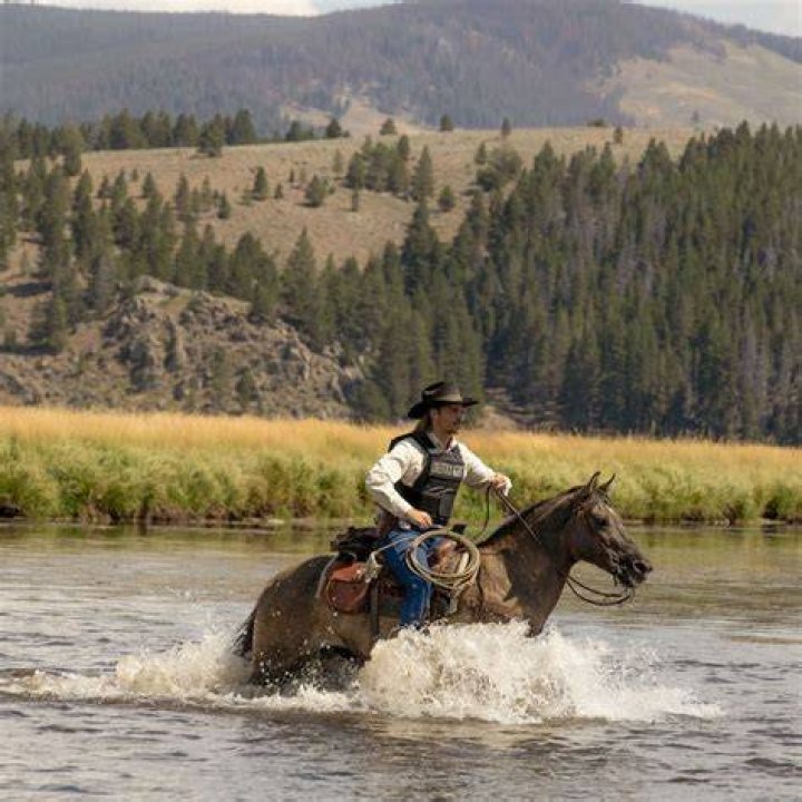 Kayce Dutton on a horse with other men behind him in Yellowstone