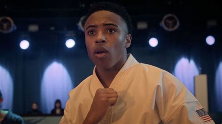 Kenny from Cobra Kai season 4, wearing a black uniform