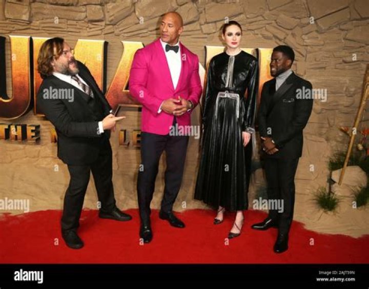 Kevin Hart, Dwayne Johnson, Karen Gillan and Jack Black on a sand dune in Jumanji: The Next Level