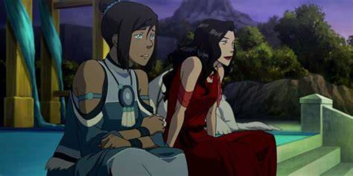 Korra and Asami sit next to each other in elegant clothing in the Legend of Korra