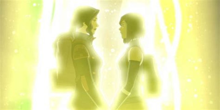Korra and Asami stand in a yellow glow