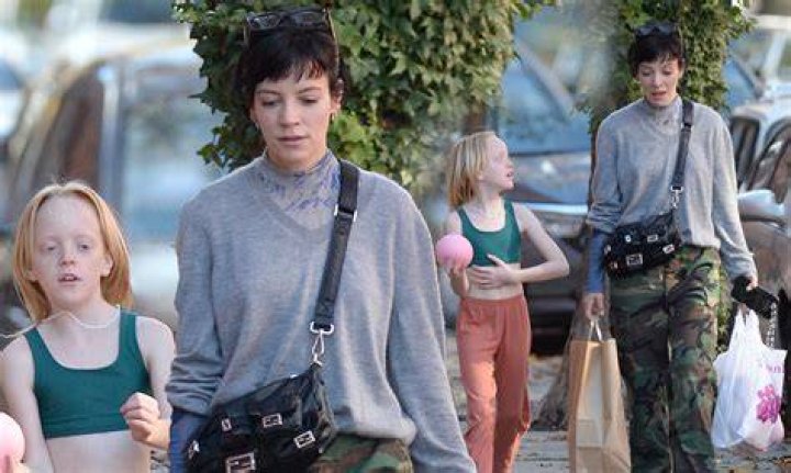 Lily Allen giggles as she heads out with husband David Harbour and