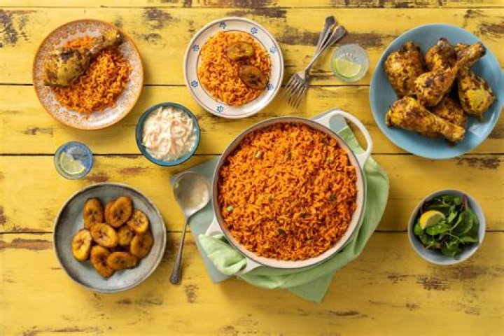 “Lobola Price Has Gone Up”: Video Shows Moment White Lady Kneeling to Serve People Hot Jollof Rice in Kitchen