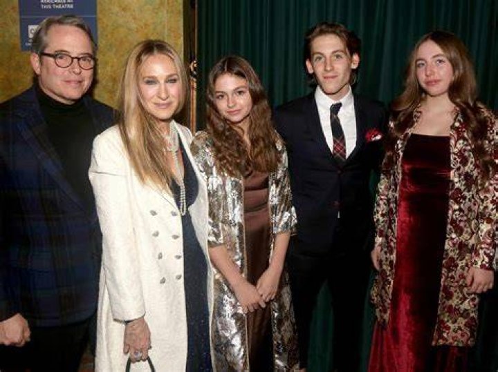 Matthew Broderick with lipstick on his cheek and two actors on dog tags
