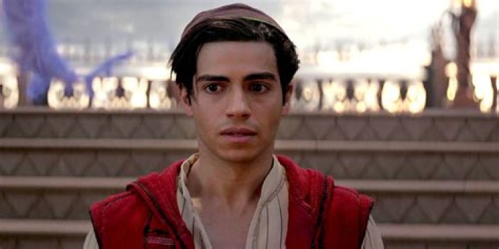 Mena Massoud in Aladdin is looking at something off-screen.