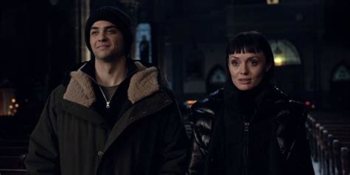 Owen (Noah Centineo) and Max (Laura Haddock) in The Recruit in front of a window