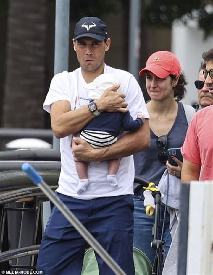 Rafael Nadal cradles his baby boy as he and wife Xisca take in a Sydney