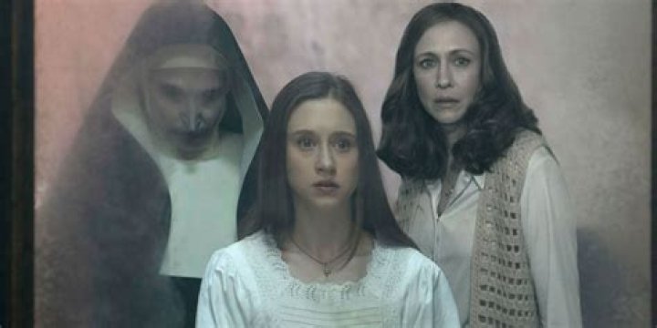 Sister Irene and Lorraine Warren looking intently at something in The Nun II and The Conjuring