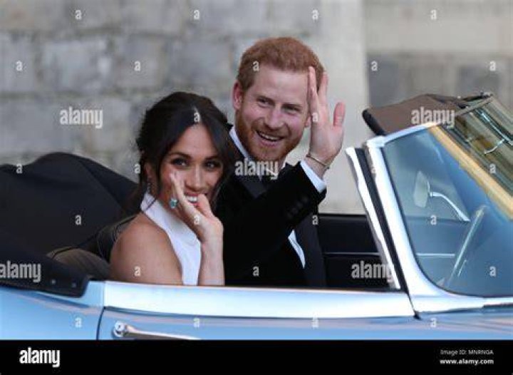 The newly married Duke and Duchess of Sussex, Meghan Markle and Prince Harry, leave Windsor Castle after their wedding in Windsor, England, to attend an evening reception at Frogmore House. Photo / AP