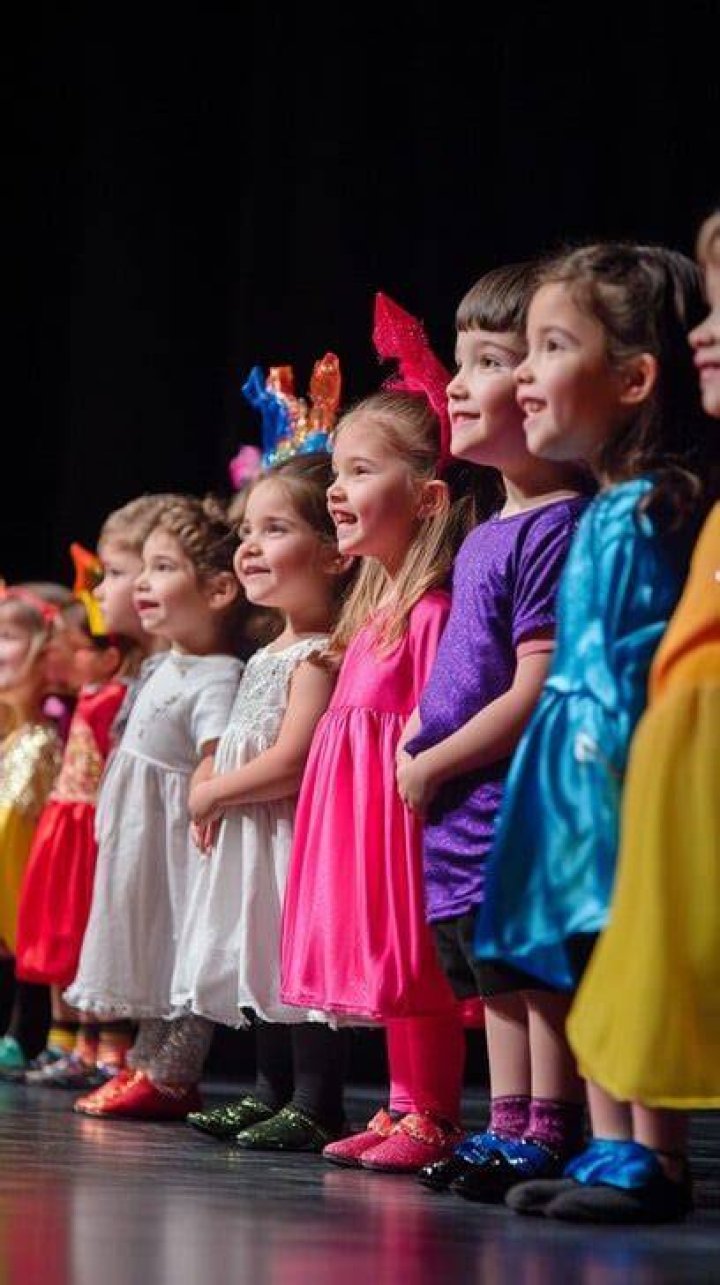 Theater Camp: Kids lined up on stage looking out at their directors down below&nbsp;