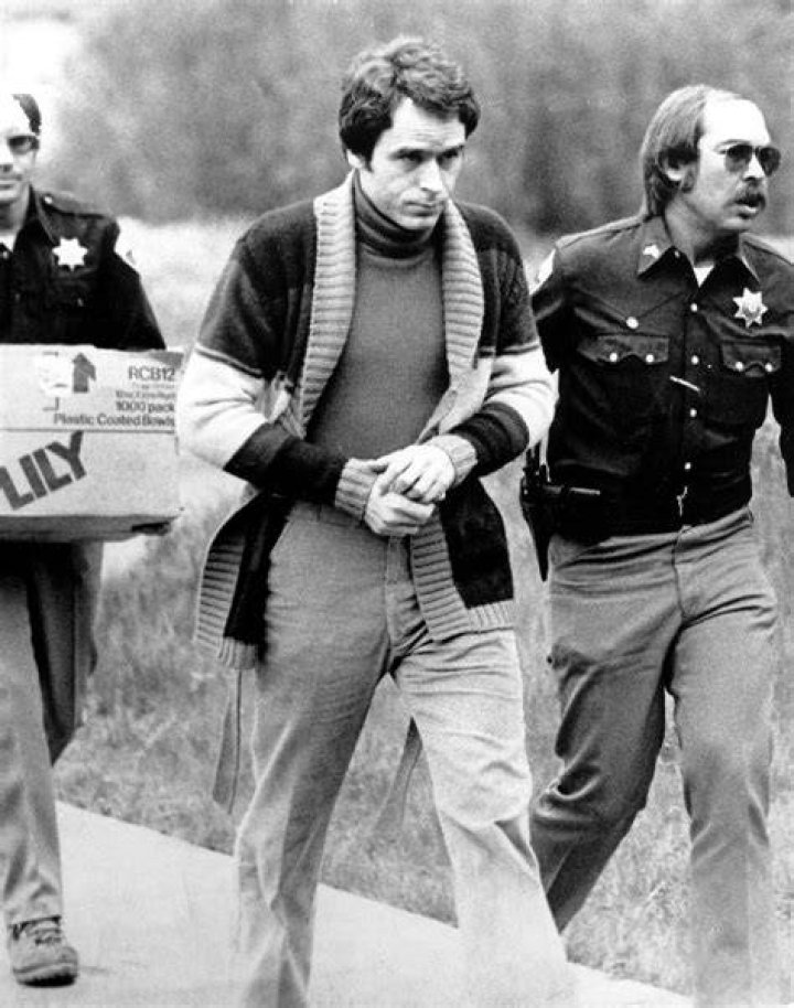 Theodore Bundy walks forward and waves to TV camera as his indictment for the January murders of FSU coeds Lisa Levy and Margaret Bowman is read. Photo / Getty Images 
