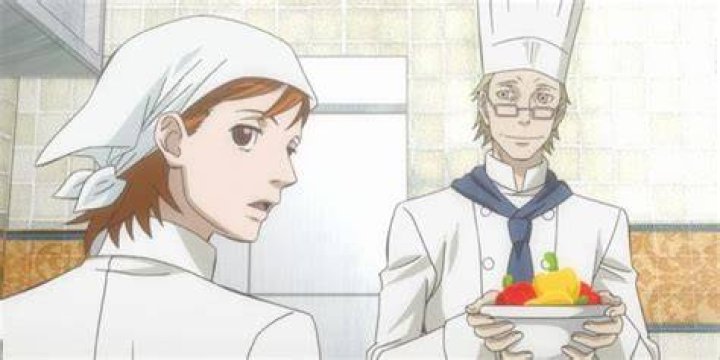 two chefs from Ristorante Paradiso, one of them looks suspicious, the other is smiling and carrying a bowl of ingredients