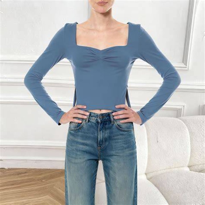 Two-piece side slit crop top with asymmetric neck and high-waist belted pants
