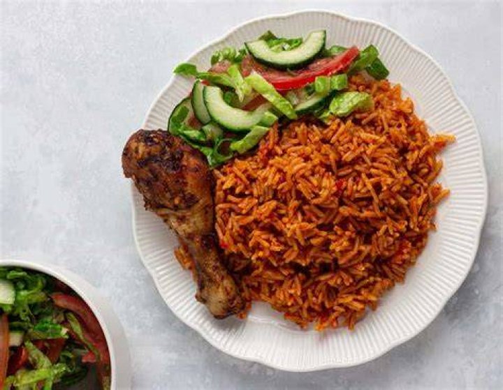 White lady and jollof rice/lady knelt and dished food. White lady and jollof rice/lady knelt and dished food.