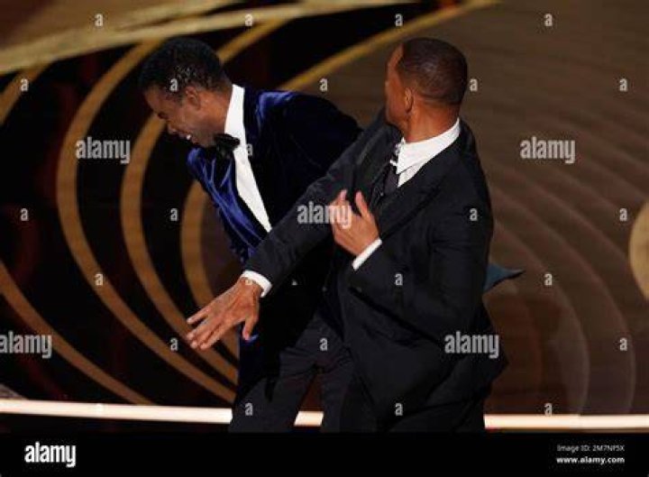 Will Smith, right, hits presenter Chris Rock on stage at the Oscars. Photo / AP