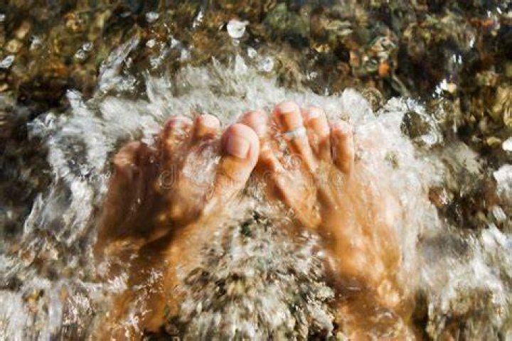 Woman feet pounded by wavs stock photo. Image of blue 15975360