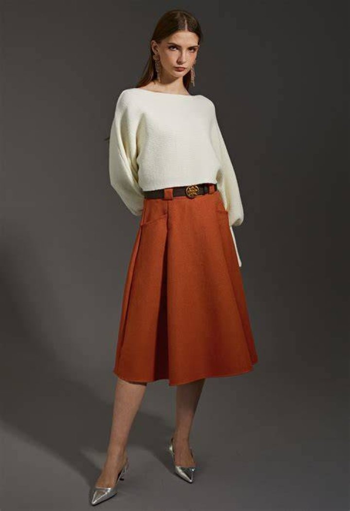 Woman in orange midi skirt