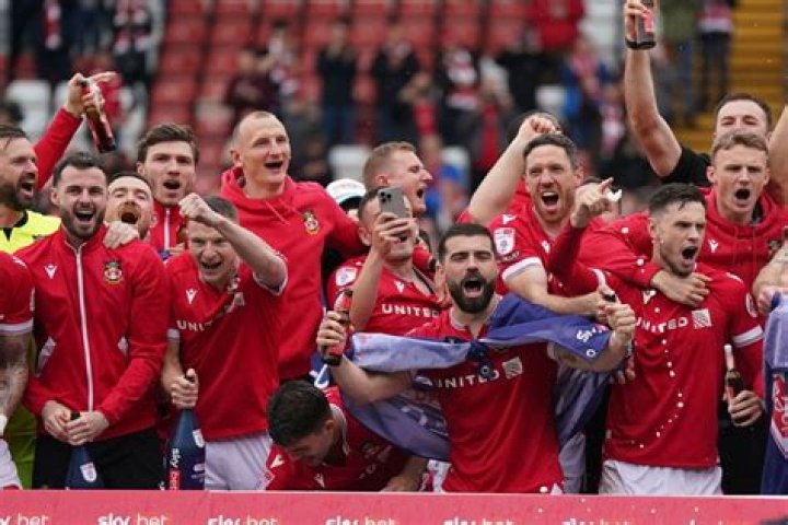 Wrexham players celebrate their promotion to the EFL at The Racecourse Ground, in Wrexham, Wales. Photo / AP